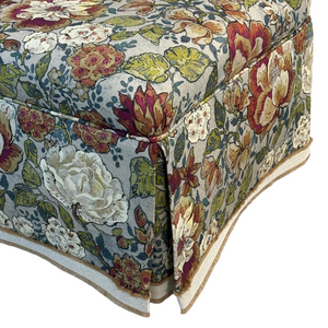 Floral patterned fabric settee with a white background