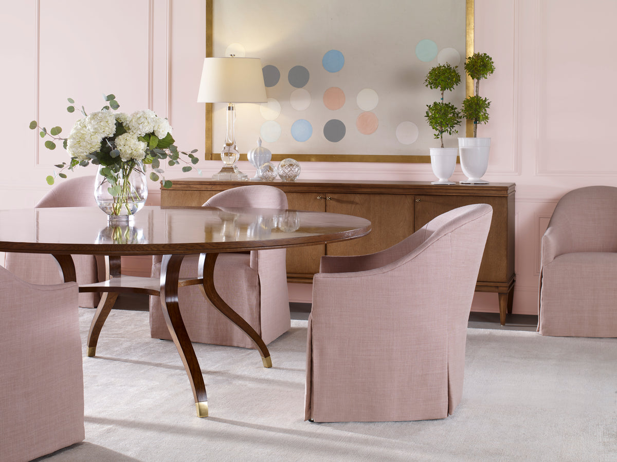 Refined dining room with blush upholstered chairs, round wood table, and sideboard at Kennedy Galleries Toronto.