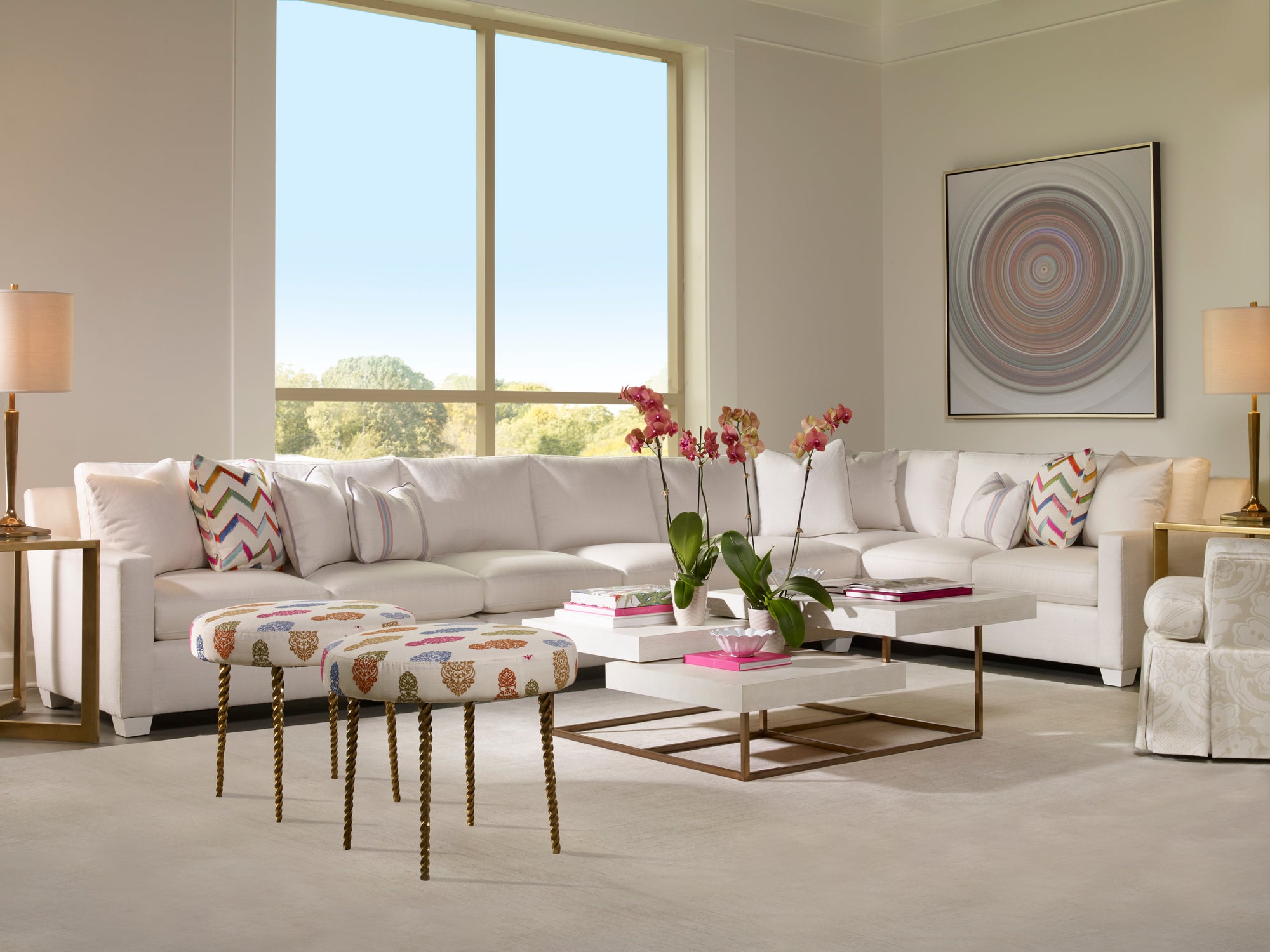 Modern living room with a white sectional sofa, coffee table, and decorative elements.