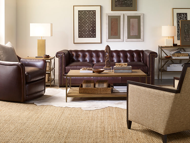 Living room with brown leather sofa, armchairs, and a coffee table.